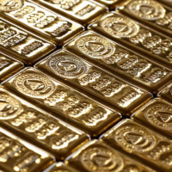 Gold slips as dollar pares losses, stocks hold ground