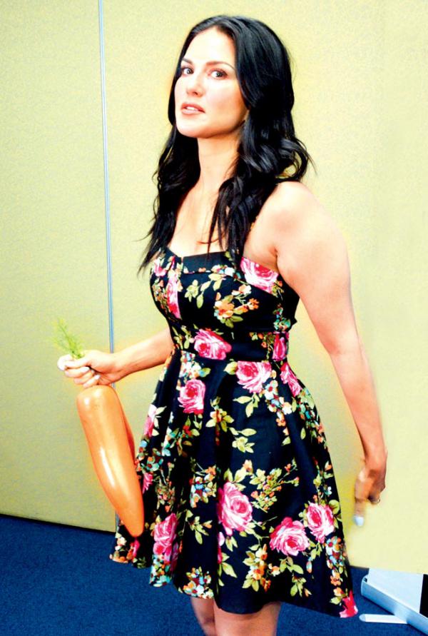 What is Sunny Leone doing with artificial carrots?