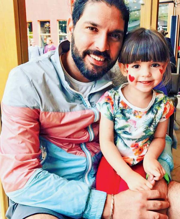 Who is the cute little girl in this photo with Yuvraj Singh?