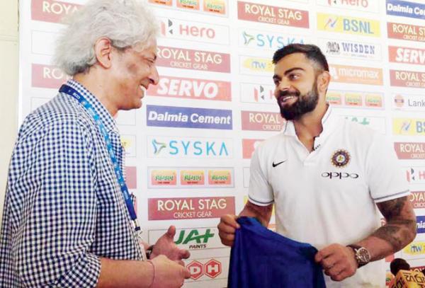 Virat Kohli gifts cricket writer a signed shirt for his century of Tests