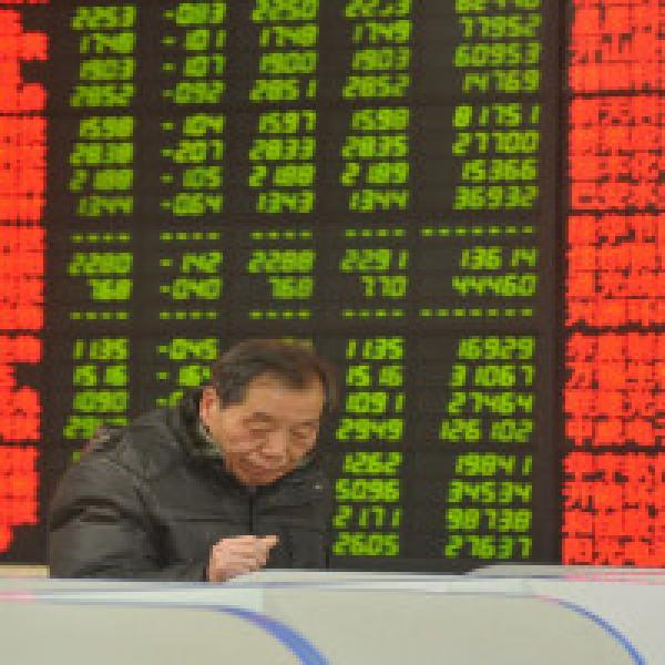 Asian shares shrug off Wall Street gloom, dollar steadies